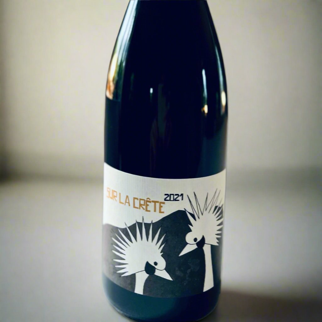 Bottle of Colline de l'Hirondelle Sur La Crête 2021 wine, a biodynamic blend of Grenache Noir and Mourvèdre, displayed against a neutral background.