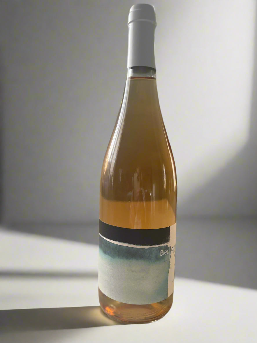 A striking bottle of Colline de l'Hirondelle Bleu orange wine, showcasing an elegant label with artistic details that embody the wine's refined craftsmanship and rich heritage. This wine reflects the distinct character of artisanal orange winemaking.