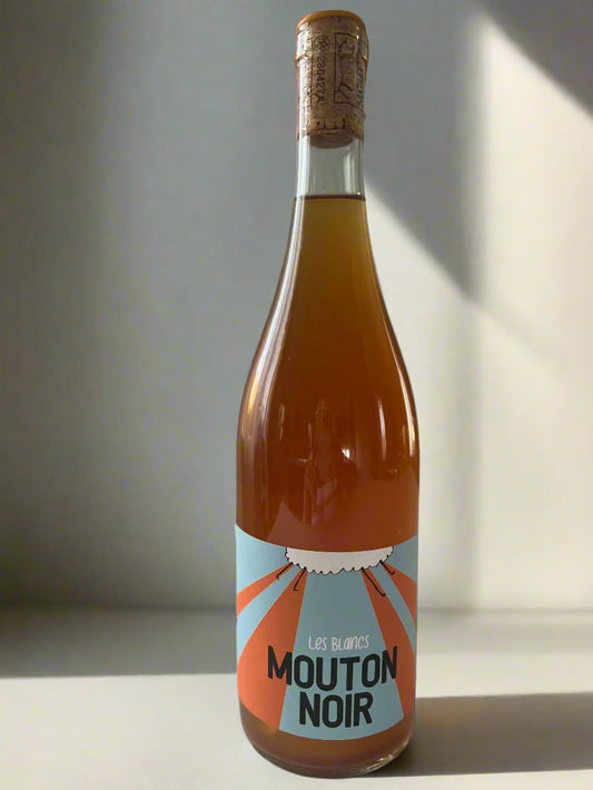 A beautifully designed bottle of Mouton Noir Les Blancs orange wine, featuring a bold and modern label that reflects the wine's innovative character. The bottle highlights the unique qualities of orange wine, crafted with care and expertise.